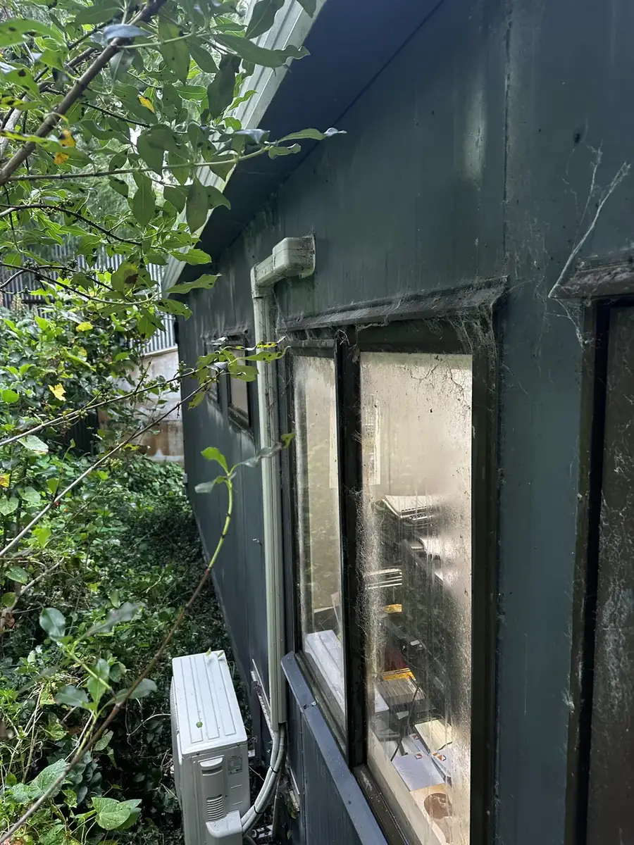 Heavy spider webbing on window frames and eaves before treatment, Pest OFF Company Auckland